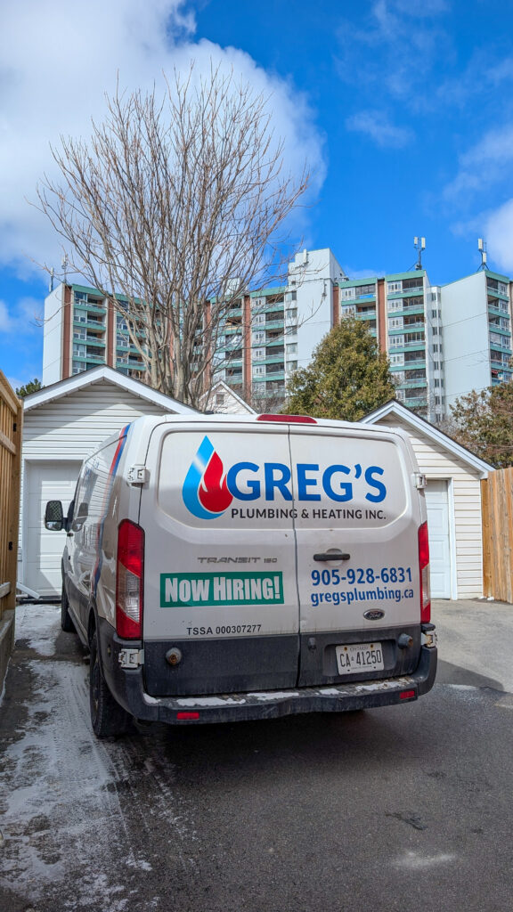 Greg’s Plumbing and Heating van parked near a residential building