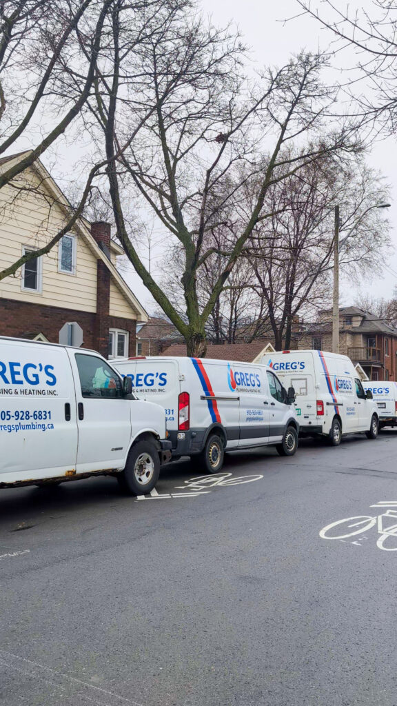 Greg’s Plumbing and Heating service vans lined up for plumbing calls