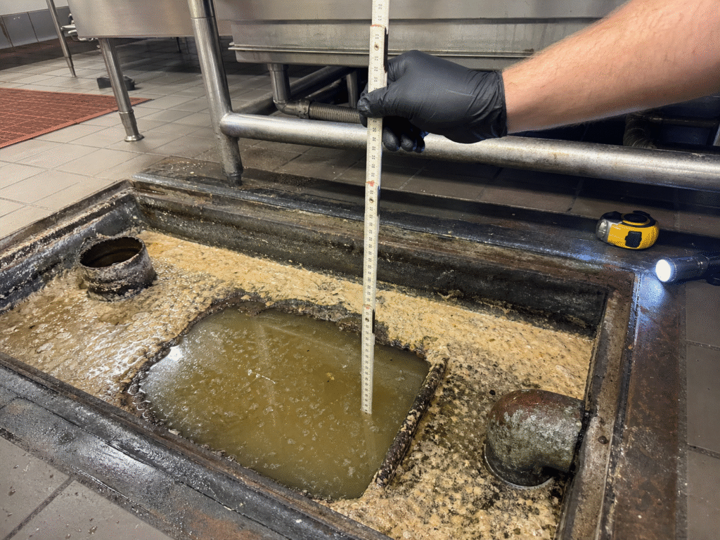 Measuring grease and solids inside a commercial grease trap before pump out